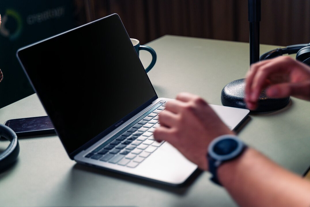 mystery writer at desk with laptop