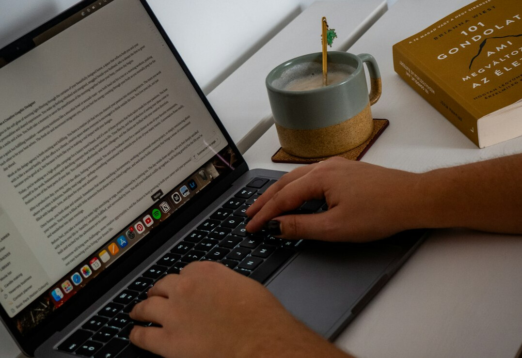 writer typing mystery novel on laptop