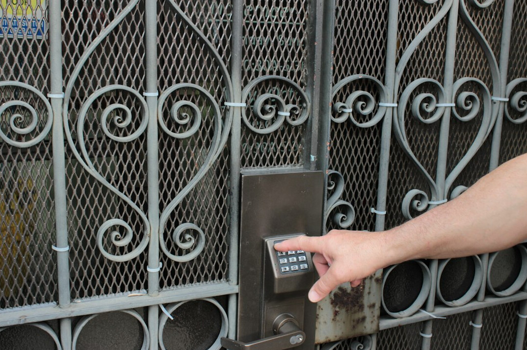 person turning key in lock
